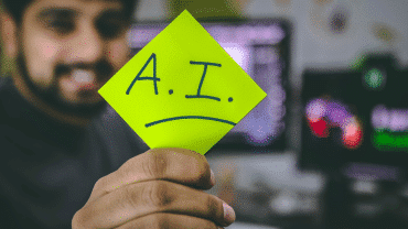 A person holding an AI sign