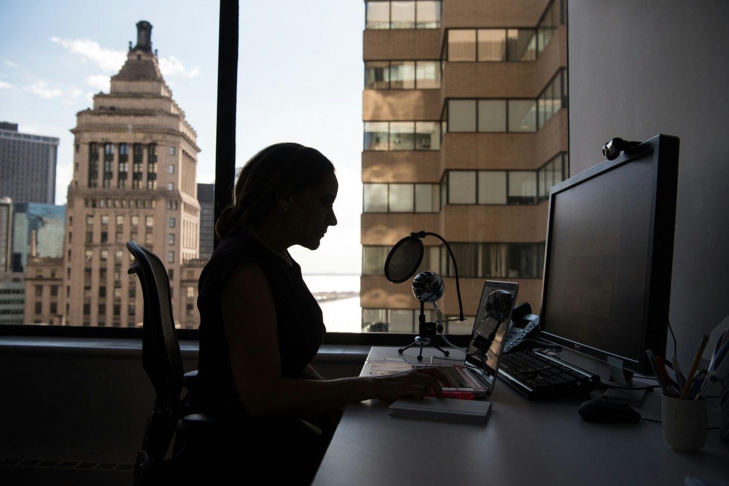 woman sitting on her desk in her office